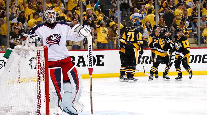 PITTSBURGH, PA - APRIL 12: Bryan Rust #17 of the Pittsburgh Penguins celebrates his second period goal with teammates behind Sergei Bobrovsky #72 of the Columbus Blue Jackets in Game One of the Eastern Conference First Round during the 2017 NHL Stanley Cup Playoffs at PPG Paints Arena on April 12, 2017 in Pittsburgh, Pennsylvania. (Photo by Gregory Shamus/Getty Images)
