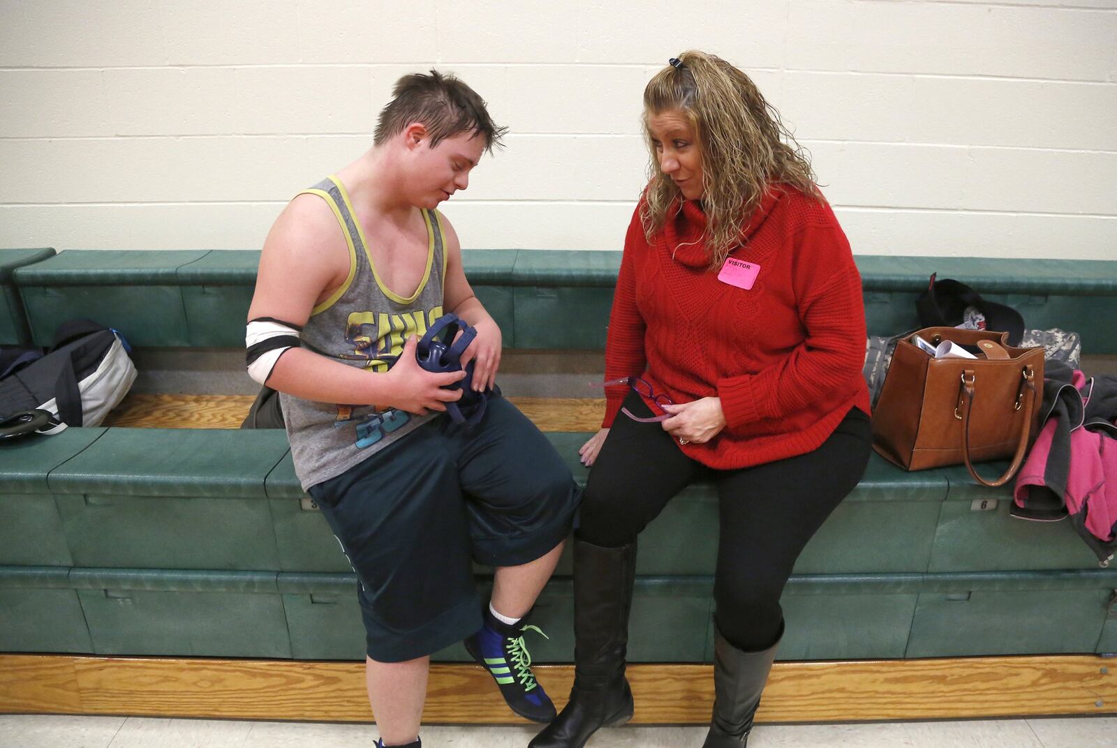 Brooks Henning, who wrestlles with the National Trail High School team, receives encouragement from his mother, Tanya Henning during practice. Henning has Down Syndrome, and recently began wrestling with the team. LISA POWELL / STAFF