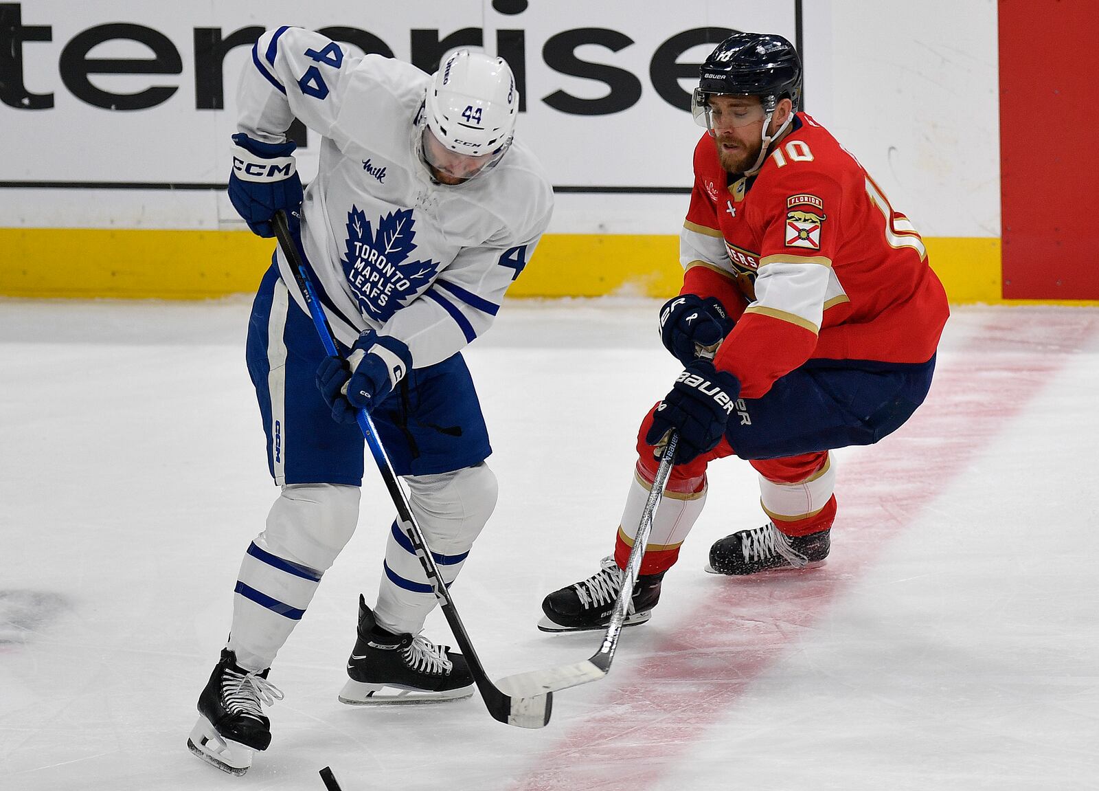 Toronto Maple Leafs defenseman Morgan Rielly (44) battles Florida Panthers left wing A.J. Greer (10) for the puck during the first period of Game 4 of a second-round NHL hockey playoff series, Sunday, May 11, 2025, in Sunrise, Fla. (AP Photo/Michael Laughlin)