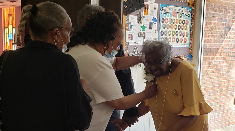 A churchgoer pins a corsage on Verdell Dawson in honor of her 100th birthday at Summit Christian Church on Sunday. JESSICA GRAUE/CONTRIBUTED