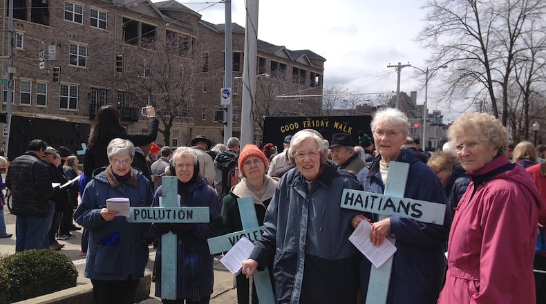 Sisters of the Precious Blood of Dayton carry crosses during a Good Friday walk that show what they've been praying about: support for Haitian immigrants and an end to violence and pollution. Photo provided.