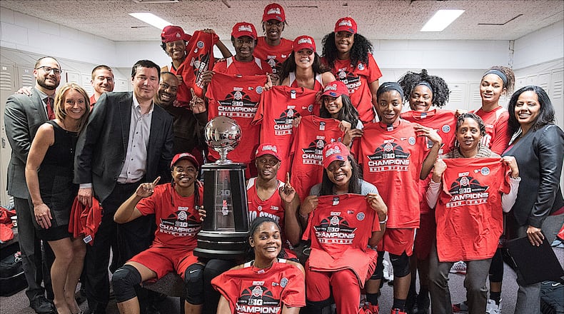 The Ohio State women's basketball team poses in the locker room with the Big Ten championship trophy. (Photo courtesy Ohio State Athletics Communications)