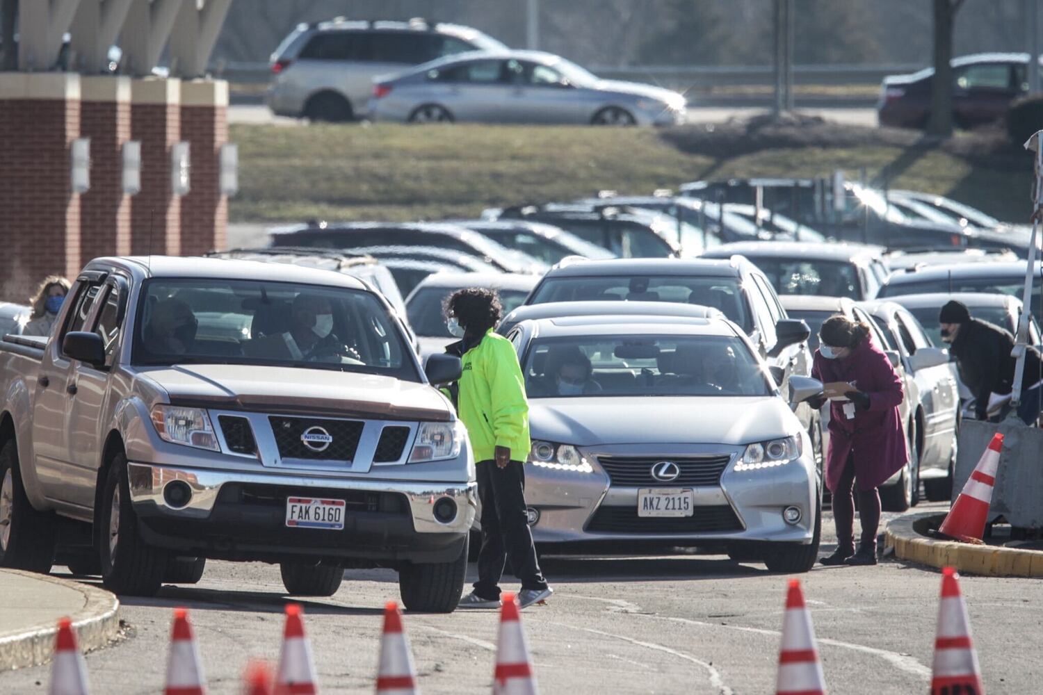Cars line up for a coronavirus vaccine clinic at UD Arena