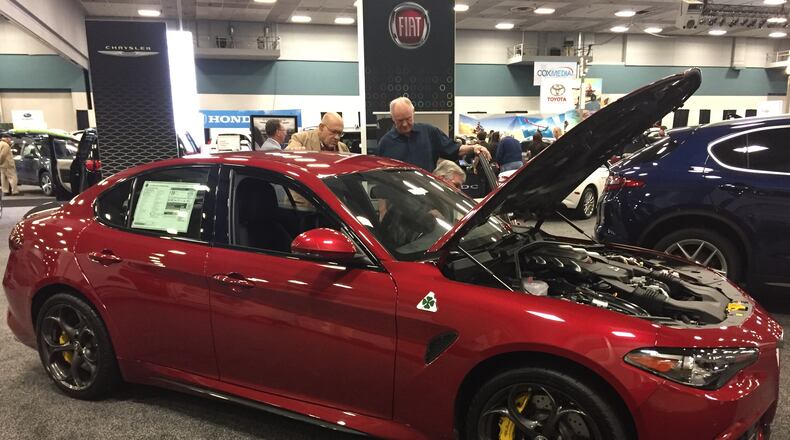 Consumers are shown at the Dayton Auto Show earlier this year. Montgomery County leaders approved increasing the sales tax here, but some residents want the issue on the ballot. AMY ROLLINS/STAFF