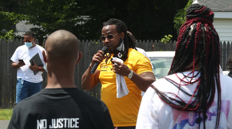 Dion Green, organizer of the "No More Silence, End Gun Violence" rally and march, speaks during the event Saturday. BILL LACKEY
