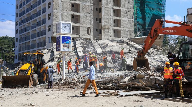 A rescue team works at the scene of a collapsed building in Nairobi, Kenya, Friday, Jan. 2, 2026. (AP Photo/Andrew Kasuku)