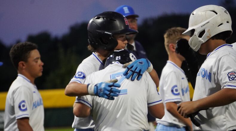 West Side Little League's Teegan Lay consoles teammate Jordan Malloy after West Side lost 9-4 to Clarendon Hills (Ill.) in the Great Lakes Region championship game at the Little League Central Region Complex in Whitestown, Indiana. CHRIS VOGT / CONTRIBUTED
