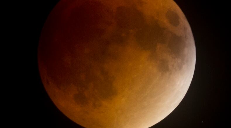 A rare Super Moon coincided with a full lunar eclipse on Sept. 27, 2015, resulting a Blood Moon between 10 p.m. and midnight. The clouds left the the sky just in time for the celestial show. This photo was made shortly after 10. TY GREENLEES / STAFF