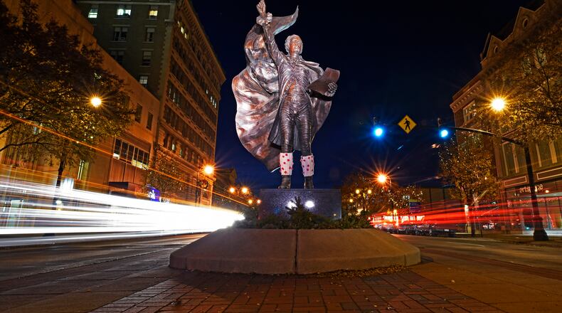 Car lights are blurred during a 20-second exposure of The American Cape sculpture of Alexander Hamilton, by metal sculptor Kristen Visbal, as cars drive by on High Street in Hamilton. NICK GRAHAM/STAFF