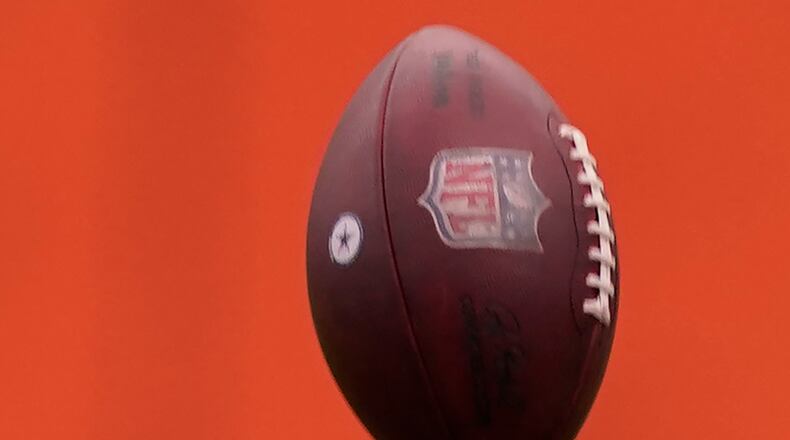Dallas Cowboys quarterback Dak Prescott reaches to catch a football he tossed into the air while warming up for an NFL training camp football practice in Frisco, Texas, Thursday, Sept. 3, 2020. (AP Photo/LM Otero)