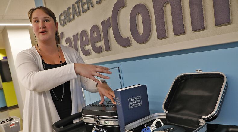 Emily Fowler, the choir director at Springfield High School, talks about the different escape room kits that will be used during the fund raiser. Bill Lackey/Staff