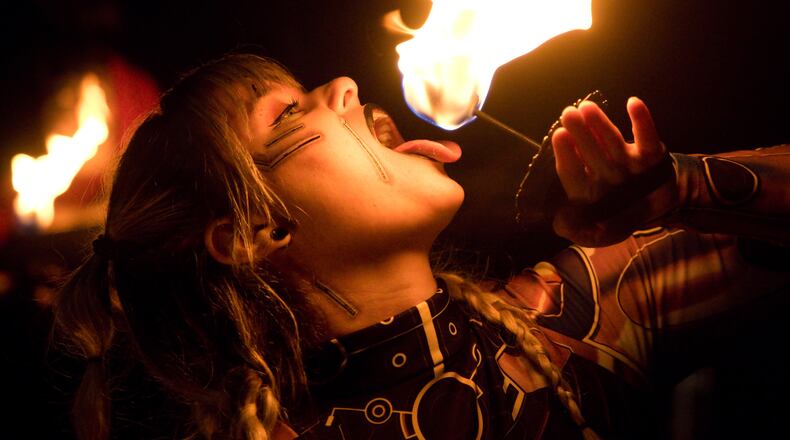 A photo of a fire performer in the Oregon District taken Oct. 28, 2023. ADAM ALONZO/CONTRIBUTED