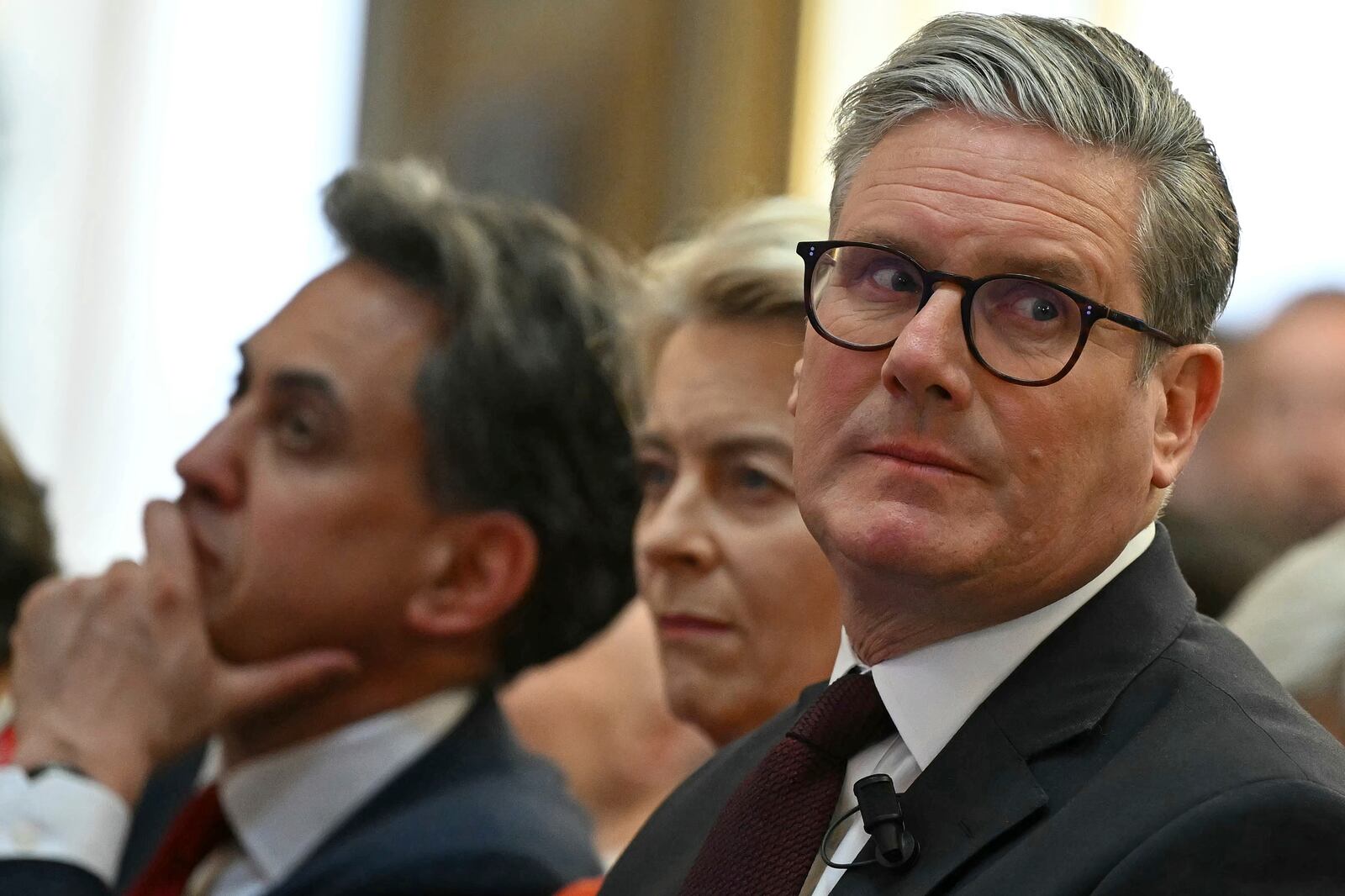 From left, Britain's Climate Change and Net Zero Secretary Ed Miliband, European Commission President Ursula von der Leyen and Britain's Prime Minister Keir Starmer listen to a speaker during the International Summit on the Future of Energy Security at Lancaster House in London, England, Thursday April 24, 2025. (Justin Tallis/Pool Photo via AP)