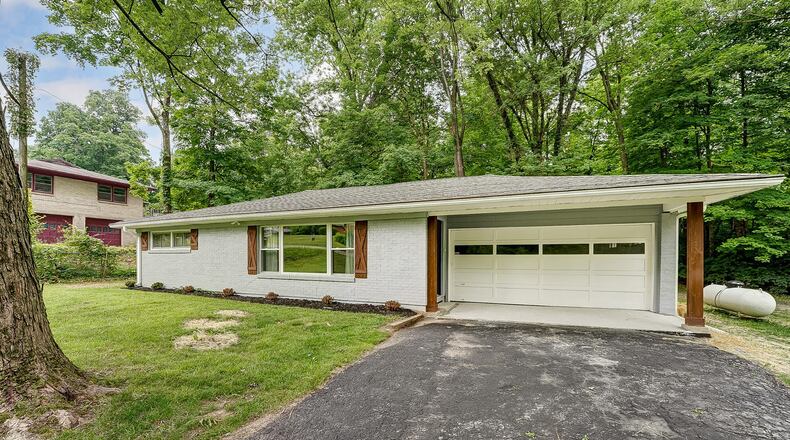 The front of the rehabbed brick ranch home features a covered garage and front entry, asphalt driveway and new landscaping. CONTRIBUTED PHOTOS