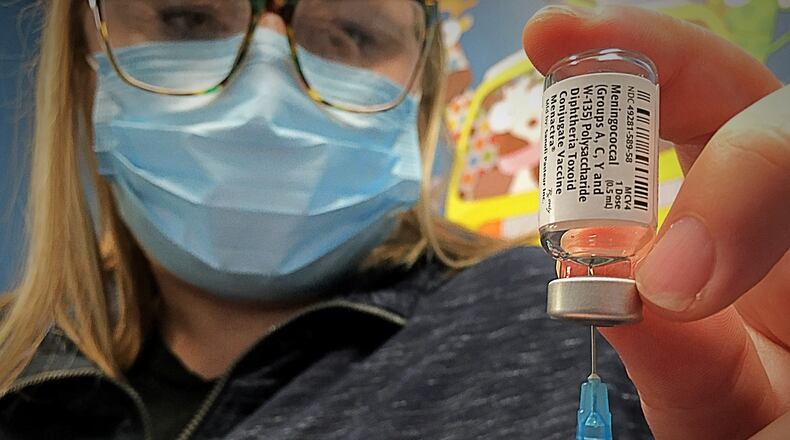 Britney Evans, RN, prepares to give a vaccine Friday, at PriMED Springboro Pediatrics, located at the Dayton Children's South Campus. The practice is continuing to reach out to parents and patients to encourage them to schedule, after health care visits fell early in the pandemic.  MARSHALL GORBY\STAFF
