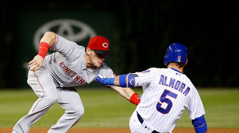 Cincinnati Reds second baseman Scooter Gennett tags out Chicago Cubs’ Albert Almora Jr. after Almora Jr. tried to stretch his hit to a double during the seventh inning of a baseball game Tuesday, Aug. 15, 2017, in Chicago. (AP Photo/Charles Rex Arbogast)