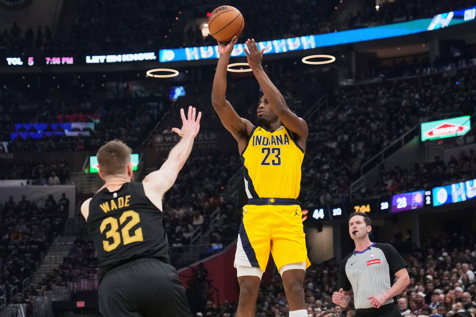 Indiana Pacers forward Aaron Nesmith, center, shoots as Cleveland Cavaliers forward Dean Wade defends during the first half in Game 5 of an Eastern Conference semifinal NBA basketball playoff Tuesday, May 13, 2025, in Cleveland. (AP Photo/Sue Ogrocki)