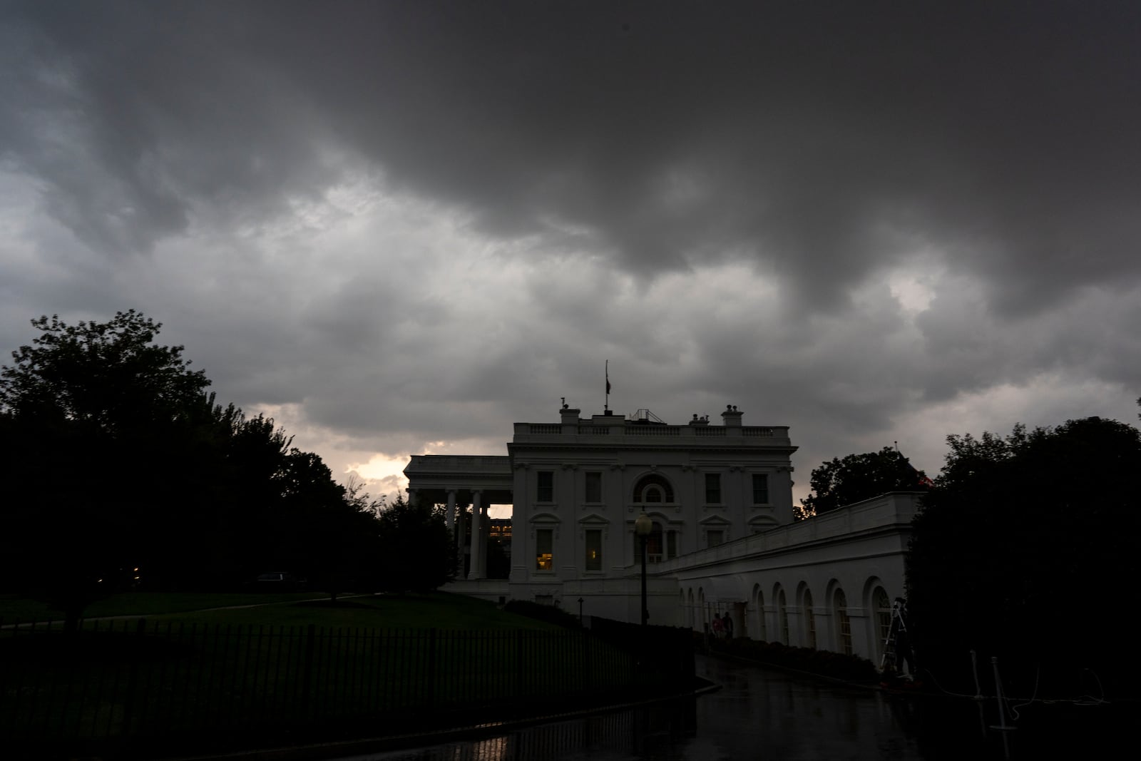 Dark clouds hover over the White House as a front of rain moves through, Monday, July 14, 2025, in Washington. (AP Photo/Alex Brandon)