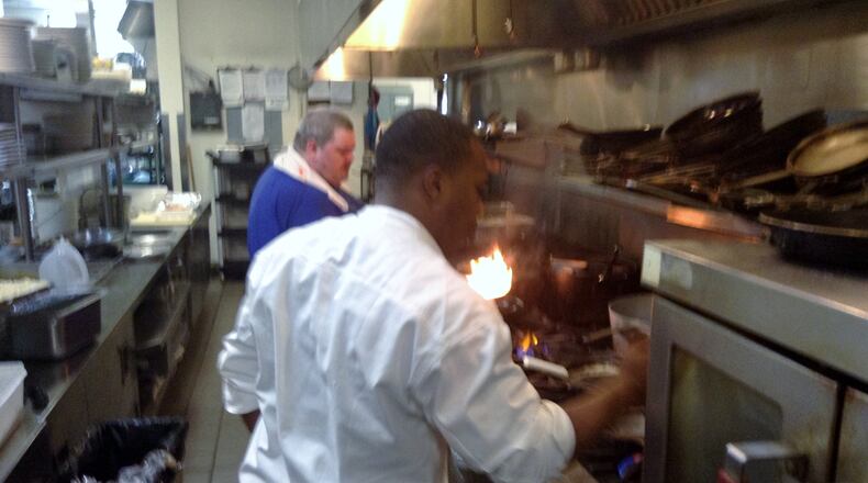 Wellington Grille Chef Durell Harrison staying busy in the Beavercreek eatery’s kitchen. The restaurant is one of several to close recently. (Staff photo by Amelia Robinson)