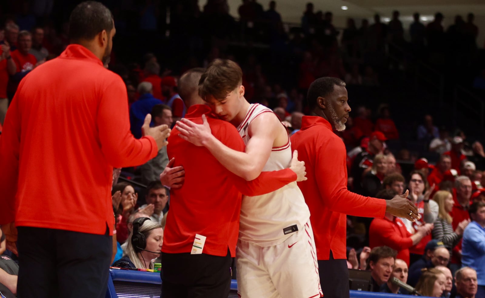 Dayton's Jordan Derkack hugs James Kane in the final moments of a loss to Illinois State in the quarterfinals of the National Invitation Tournament on Wednesday, March 25, 2026, at UD Arena. David Jablonski/Staff