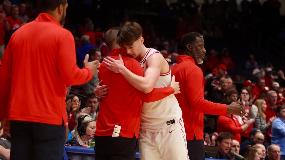 Dayton's Jordan Derkack hugs James Kane in the final moments of a loss to Illinois State in the quarterfinals of the National Invitation Tournament on Wednesday, March 25, 2026, at UD Arena. David Jablonski/Staff