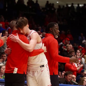 Dayton's Jordan Derkack hugs James Kane in the final moments of a loss to Illinois State in the quarterfinals of the National Invitation Tournament on Wednesday, March 25, 2026, at UD Arena. David Jablonski/Staff