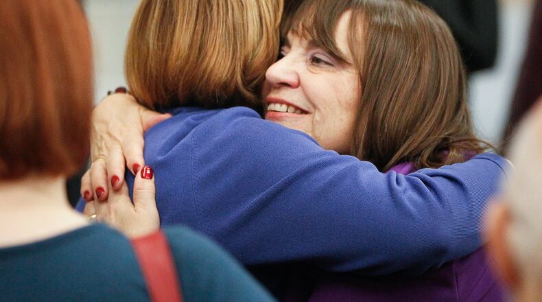 Carolyn Rice, who was sworn in as a Montgomery County commissioner on Wednesday, is hugged by fellow County Commissioner Judy Dodge. Rice’s election in November makes the board all female for the first time in county history. CHRIS STEWART / STAFF