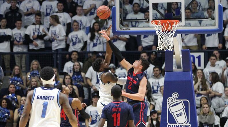 Dayton’s Sam Miller blocks a shot by Rhode Island’s Hassan Martin on Friday, Feb. 12, 2016, at the Ryan Center in Kingston, R.I. David Jablonski/Staff