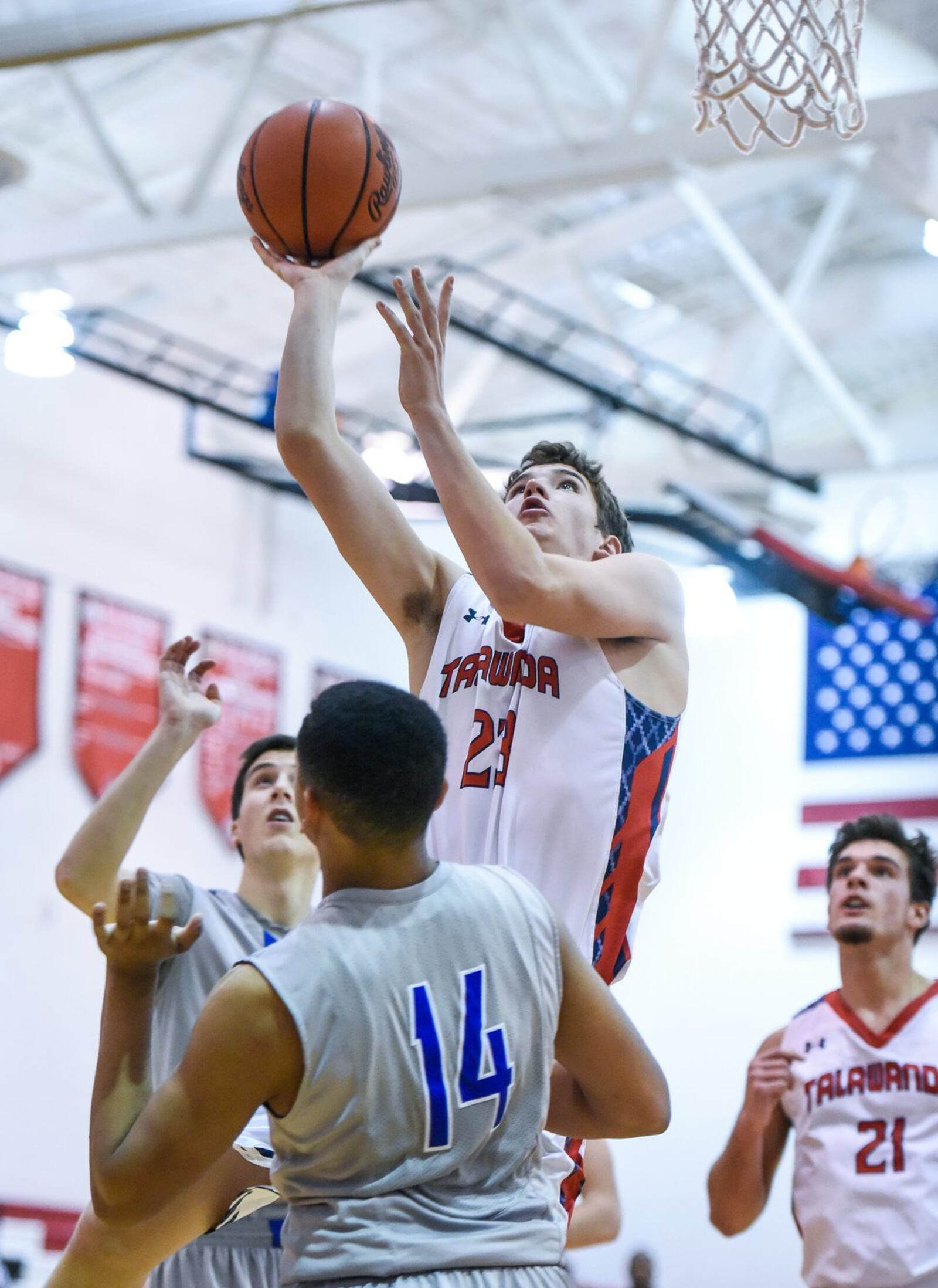 Talawanda’s Ty Hornsby puts up a shot over Cincinnati Christian’s Christian Keese (14) on Thursday night during the Brian Cook Classic in Madison Township. NICK GRAHAM/STAFF