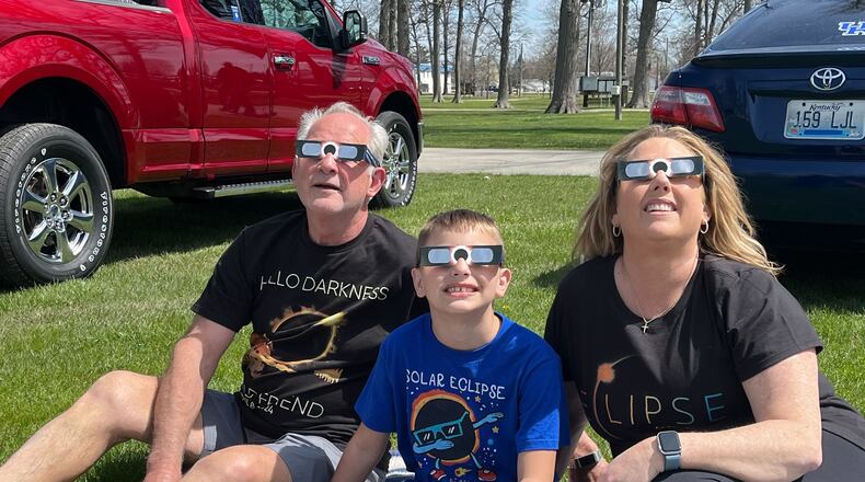 Anthony, left, and Tammy Stratton, right of Lawrenceburg, Kentucky watch the eclipse Monday, April 8 with their grandson Eli Brock of Liberty Twp. at the Darke County Fairgrounds. RICH GILLETTE/STAFF PHOTO