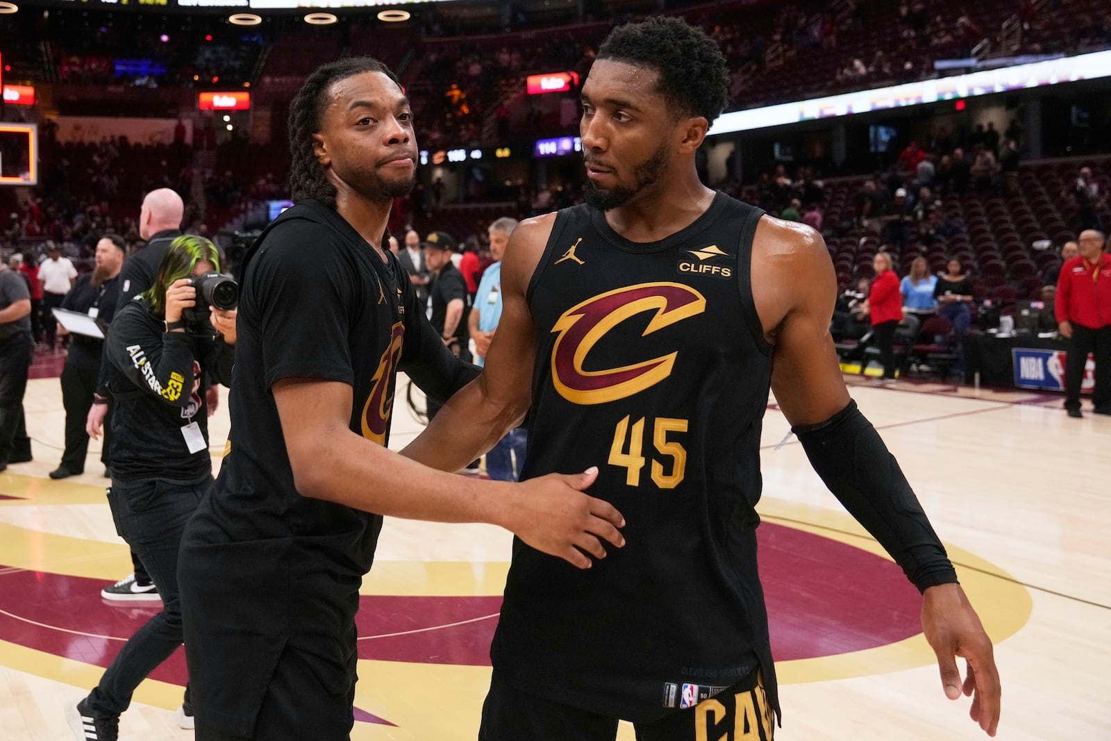 Cleveland Cavaliers guard Darius Garland, left, and guard Donovan Mitchell hug each other after the Indiana Pacers defeated the Cavaliers 114-105 in Game 5 of an Eastern Conference semifinal NBA basketball playoff Tuesday, May 13, 2025, in Cleveland. (AP Photo/Sue Ogrocki)