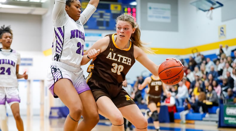 Alter High School junior Maddie Moody drives past Africentric senior Natiah Nelson during their game on Saturday afternoon at Springfield High School. The Nubians won 49-46. Michael Cooper/CONTRIBUTED