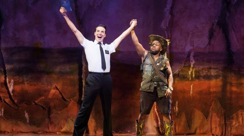 Wright State University musical theater graduate K.J. Hippensteel was in previews on Broadway in the new musical "Mrs. Doubtfire" when Broadway was shuttered due to the coronavirus pandemic. He currently resides in Shaker Heights with his family while awaiting Broadway's return. Pictured: K.J. Hippensteel (left as Elder Price) with Delroy Atkinson (General) in London's West End production of "The Book of Mormon." CONTRIBUTED PHOTO/JOHAN PERSSON