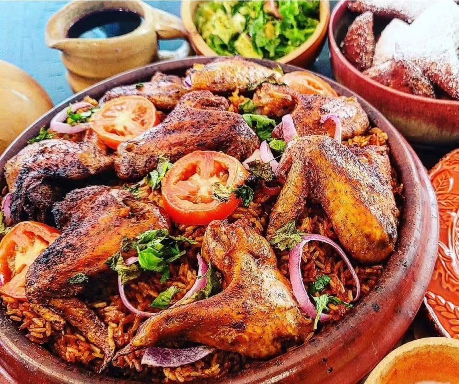 Vivian Elebiyo-Okojie, the founder of Bread of Hope, is sharing the stories of African flavors and culture through the inaugural Nomad’s Table on Saturday, May 24 in Dayton.  Pictured is a communal Jollof Rice with Chicken Wings (CONTRIBUTED).