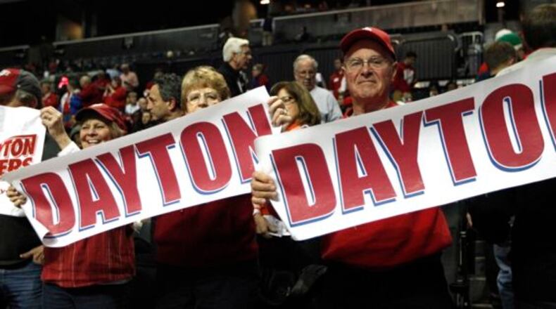 Dayton fans hold up signs during a game against Fordham in the second round of the A-10 tournament on Thursday, March 13, 2014, at the Barclays Center in Brooklyn, N.Y.