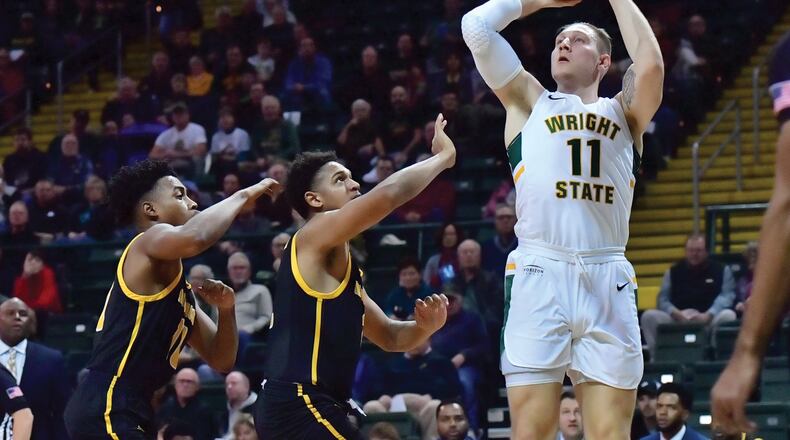 Wright State’s Loudon Love puts up a shot over two Milwaukee players during a game at the Nutter Center on Monday, Dec. 30, 2019. Joseph Craven/WSU Athletics