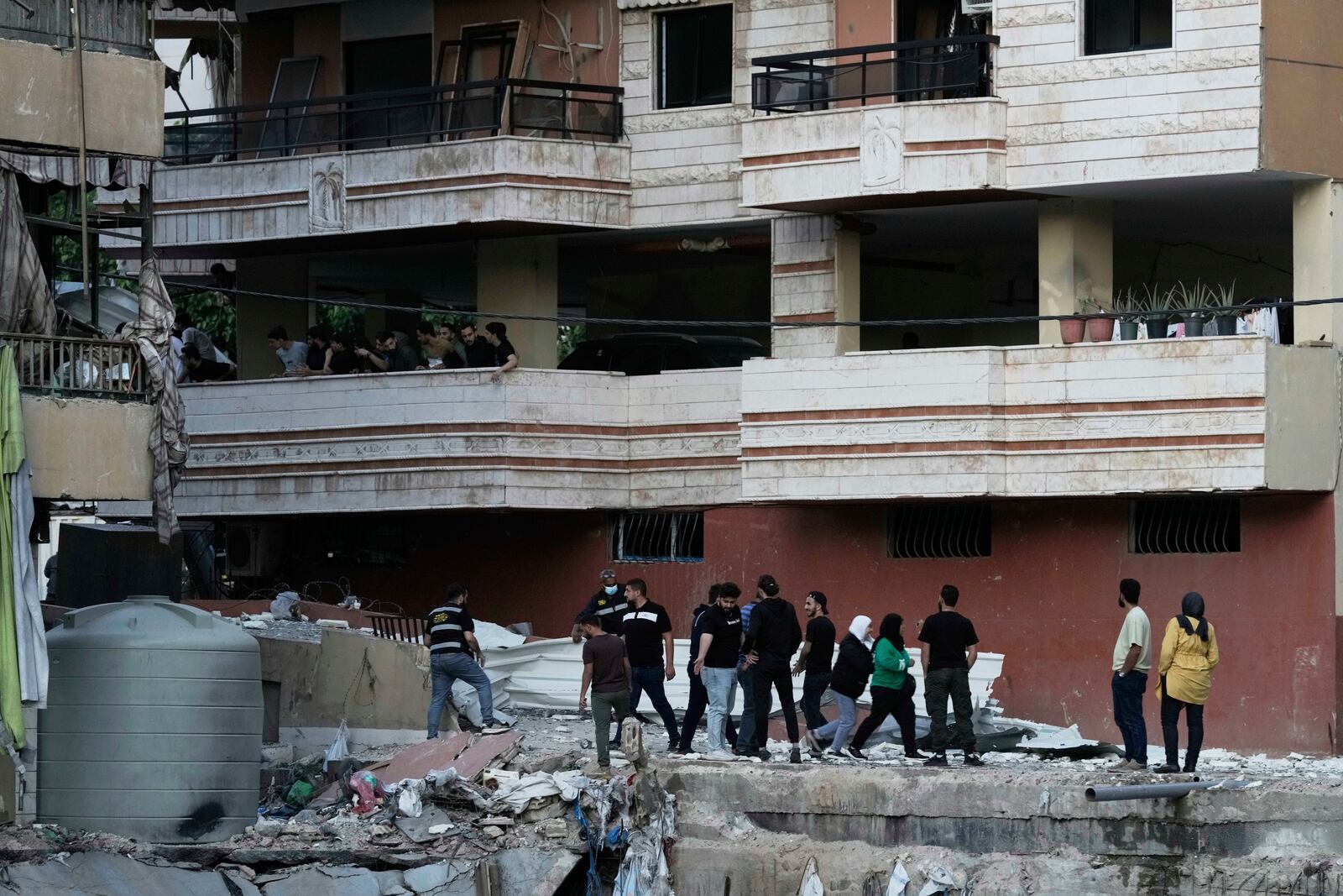 Residents inspect the area following an Israeli airstrike on Dahiyeh in the southern suburb of Beirut, Lebanon, Sunday, April 27, 2025. (AP Photo/Bilal Hussein)