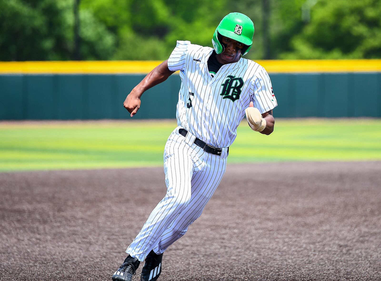 Badin junior Chandler Taylor rounds third base during a recent tournament game. KYLE HENDRIX / CONTRIBUTED