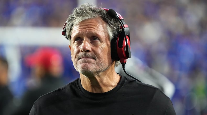 FILE - Utah head coach Kyle Whittingham looks at the scoreboard during the first half of an NCAA college football game, against BYU, Oct. 18, 2025, in Provo, Utah. (AP Photo/George Frey, File)