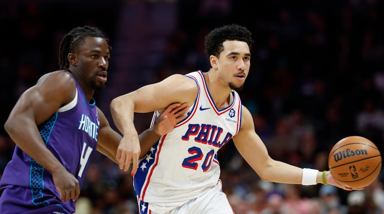 Philadelphia 76ers guard Jared McCain (20) moves the ball as Charlotte Hornets guard Sion James defends during the second half of an NBA basketball game in Charlotte, N.C., Monday, Jan. 26, 2026. (AP Photo/Nell Redmond)