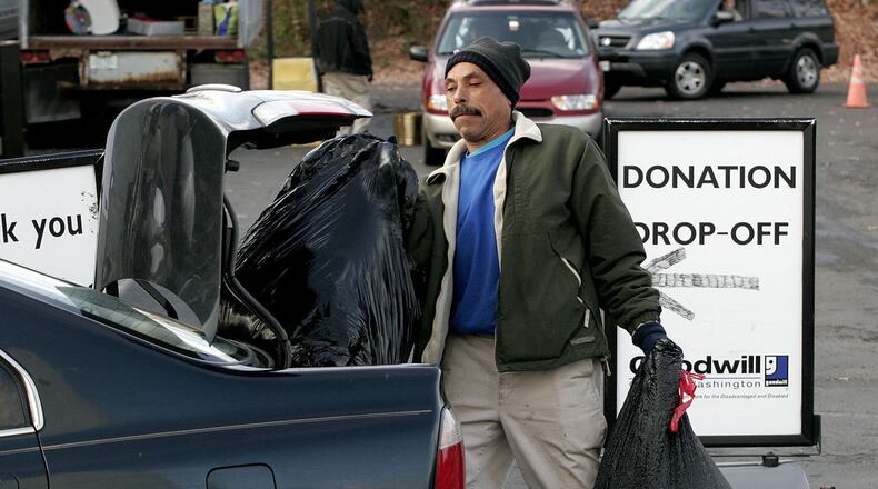 Goodwill Industries of Greater Washington employee Edward Hawkins unloads bags of donated goods at a drop-off point December 30, 2005 in Arlington, Virginia. Charity organizations like Goodwill see a surge in donations at the end of the calendar year before the tax deduction deadline. With 84-percent of its $2.39 billion in revenue going to fund social benefit programs and services, Goodwill helped place 104,010 people in jobs outside the organization in 2004.