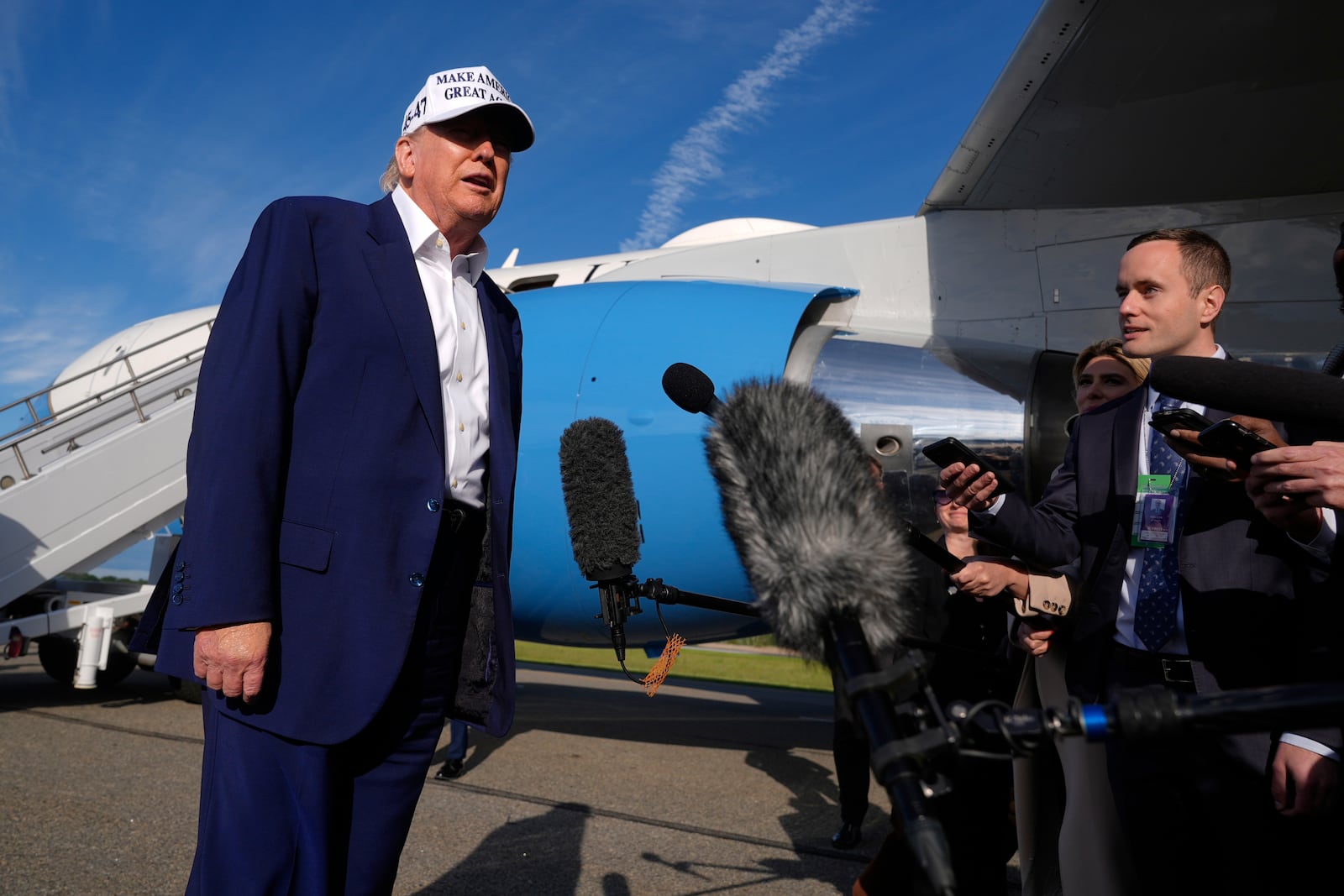 President Donald Trump speaks to reporters before boarding Air Force One at Morristown Municipal Airport in Morristown, N.J., Sunday, May 25, 2025. (AP Photo/Manuel Balce Ceneta)