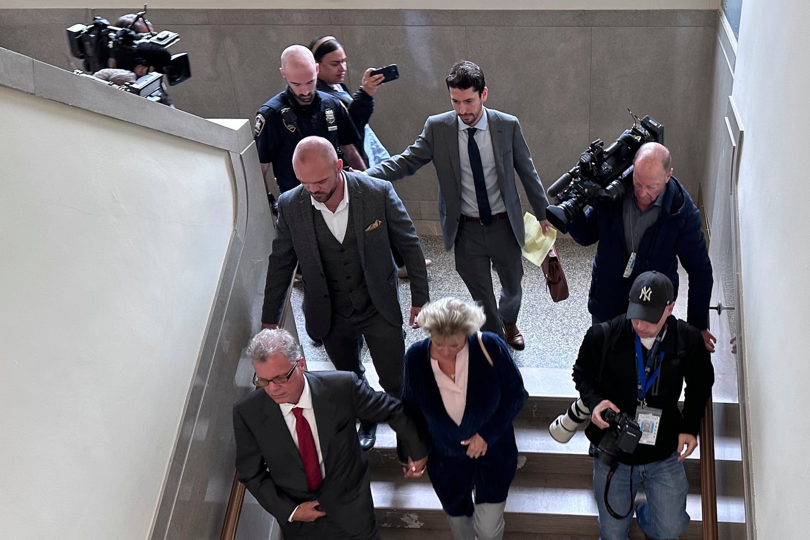 Former New York state trooper Thomas Mascia, center left, leaves Nassau County court in Mineola, N.Y. on Wednesday, May 21, 2025, after pleading guilty to charges that he shot himself and lied about it. (AP Photo/Philip Marcelo)