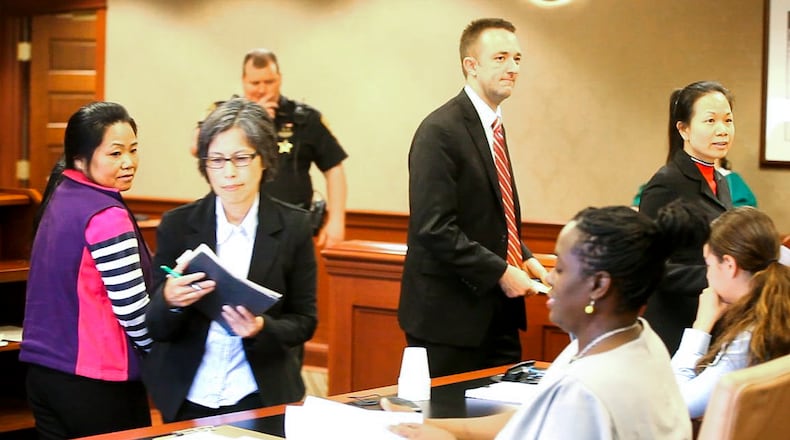 Xiaoyan Guo, left, of Cincinnati, and Yunmei Wallis, far right, of Dayton who were both arrested for promoting prostitution during a Fairfield Twp. massage parlor raid, appeared before Judge Charles Pater in Butler County Common Pleas Court, Tuesday, June 2, 2015, for a pretrial hearing. GREG LYNCH / STAFF