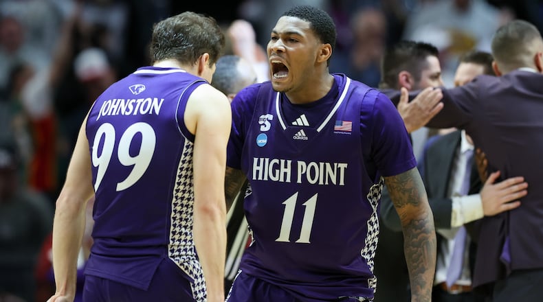 High Point forward Cam'ron Fletcher (11) celebrates with guard Chase Johnston (99) during the second half in the first round of the NCAA college basketball tournament against Wisconsin, Thursday, March 19, 2026, in Portland, Ore. (AP Photo/Amanda Loman)
