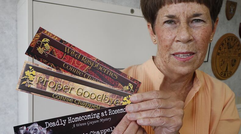 Connie Chappel holds some of the book marks from the novels she’s written. Connie is retiring as the City Clerk for the City of Springfield to concentrate on her writing full time. Bill Lackey/Staff