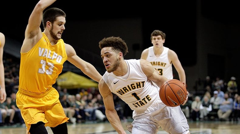 Point guard Justin Mitchell, driving on John Kiser, had seven of Wright State’s 22 turnovers in Saturday’s loss to Valparaiso. TIM ZECHAR / CONTRIBUTED