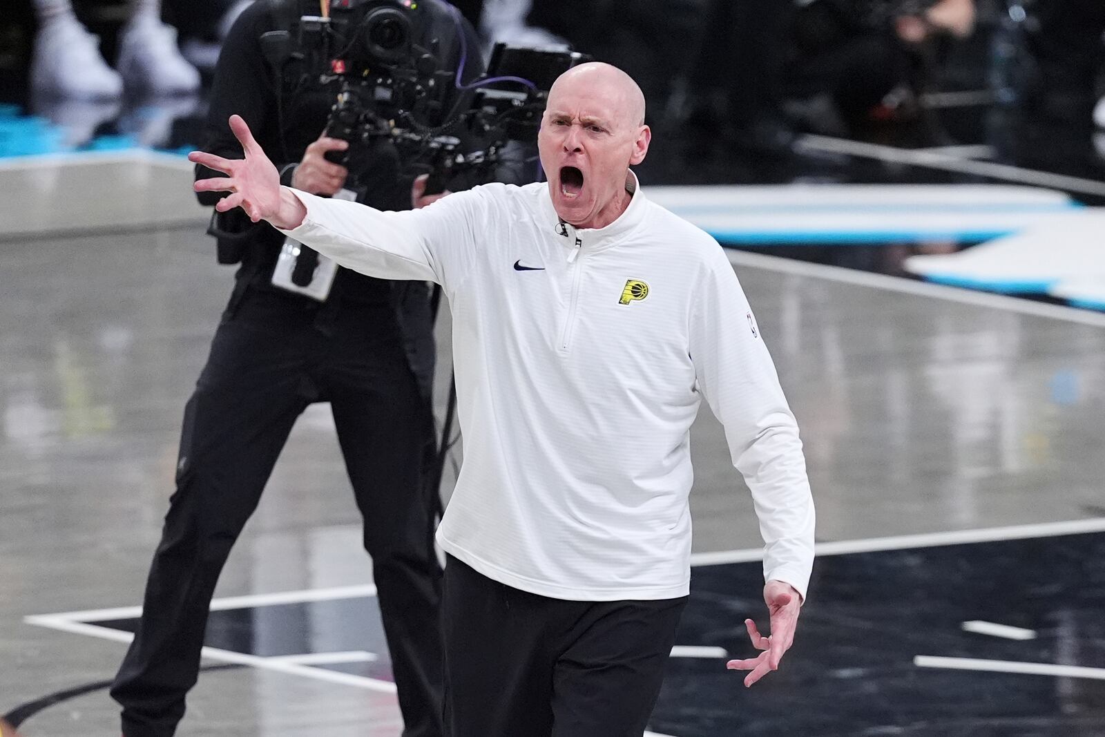 Indiana head coach head coach Rick Carlisle questions a call during a timeout during the second half of a first-round NBA basketball playoff game against the Milwaukee Bucks in Indianapolis, Tuesday, April 22, 2025. (AP Photo/Michael Conroy)
