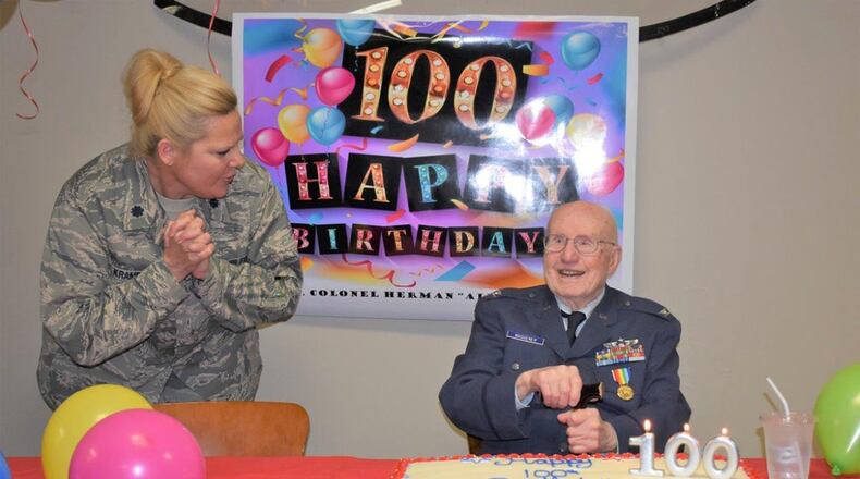 Lt. Col. Karen Kramer (left), 88th Medical Group Public Health Flight commander, leads a group of Team Wright-Patt Airmen in singing to Herman ‘Alf’ Waggener, retired U.S. Air Force colonel and World War II fighter pilot at Wright-Patterson Air Force Base, Feb. 25. Airmen at WPAFB helped Waggener celebrate his 100th birthday. (U.S. Air Force photo/Leticia Hopkins)