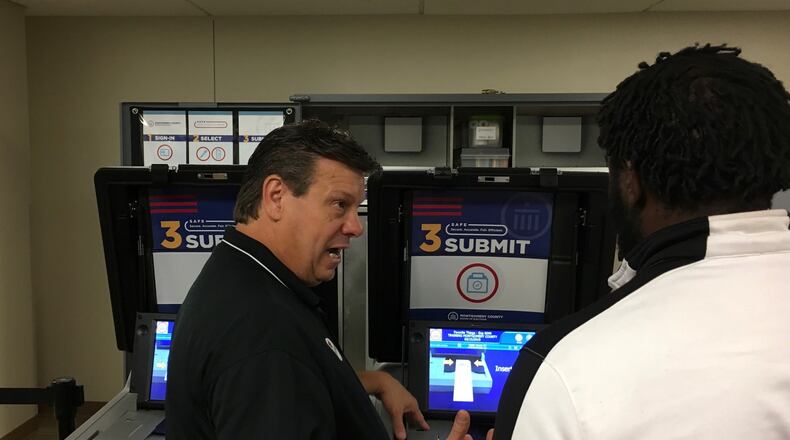 Steve Harsman, deputy director of the Montgomery County Board of Elections, explains how new voting machines function. BONNIE MEIBERS/ STAFF